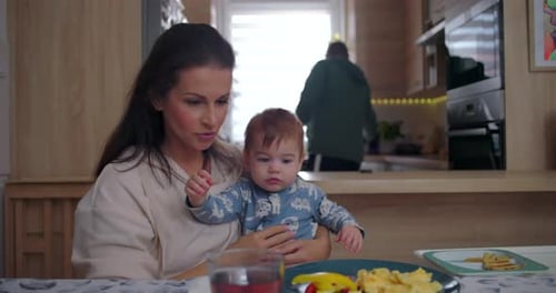 Mother with Baby and Family Meal at Home
