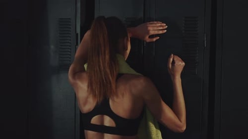 Frustrated Athlete Hitting Gym Locker Door