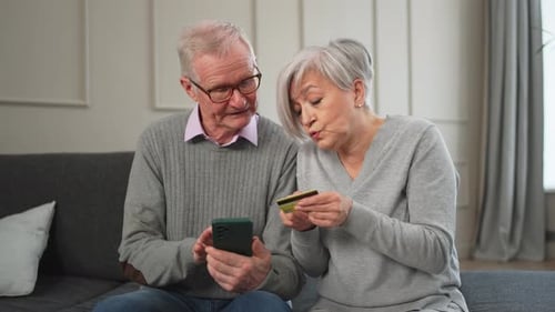 Senior Couple Man Woman Shopping Online with Smartphone Paying with Credit Card Old People Buying on