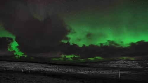 Time lapse of the aurora borealis (the northern lights) on a snowy night. Filmed in the village of B