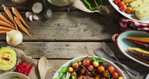 Close up view of multiple food ingredients and vegetables on wooden surface