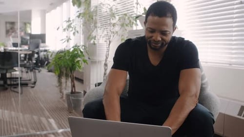 Creative Businessman Using Laptop in Office 4044 Years