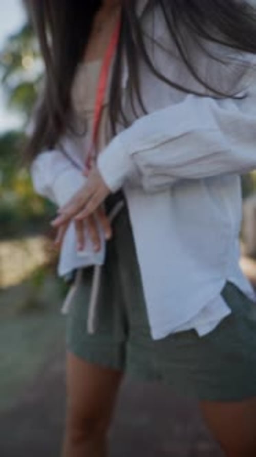 Stylish Young Woman Dancing Outdoors in Urban Setting