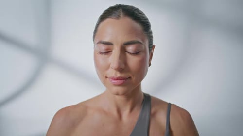 Woman with Closed Eyes Posing Indoors
