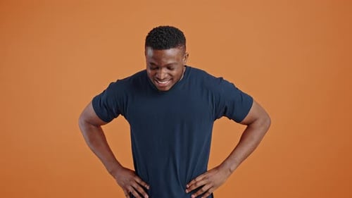 Slow Motion Overjoyed African Man Clenches Fists and Screams From Happiness Looking at Camera