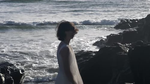 Woman in White Dress Standing Near Ocean
