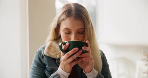Woman, drinking coffee and thinking in cafe for relax with aroma, daydreaming