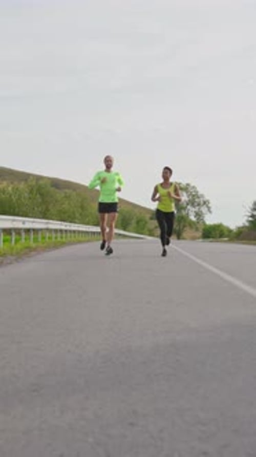 Couple Running Together on Rural Road for Fitness
