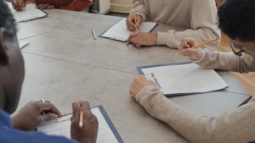 Young Adults Taking a Grammar Test at Table