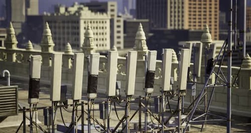 Modern 5G Cellular Network Antennas on City Rooftop Panorama