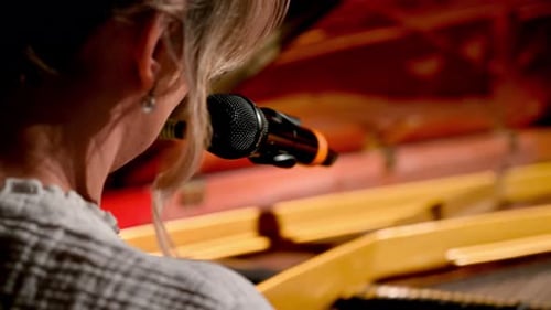 Woman Playing Yellow Piano With Microphone Close Up