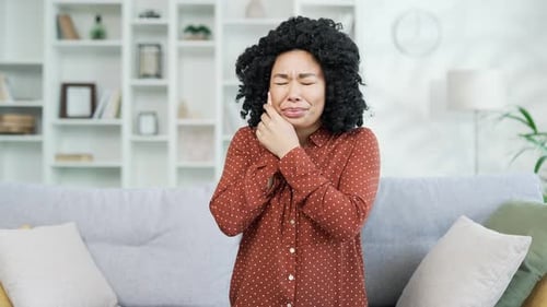Adult Woman Experiencing Tooth Pain at Home