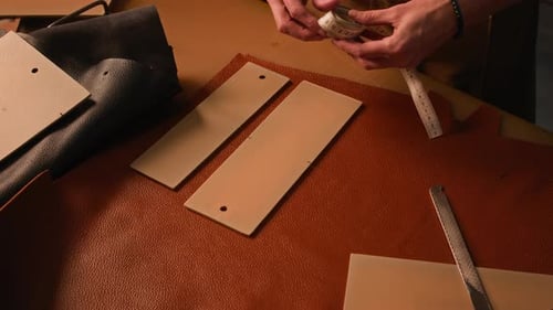 Leather Worker Measuring and Cutting Leather Material