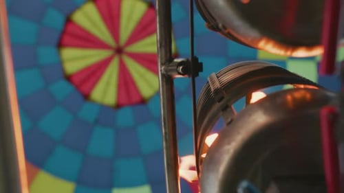 Metal Burner Firing Flame Into Colorful Hot Air Balloon From Close Up Angle
