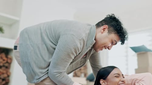 Happy couple, box and moving in fun new home, real estate or hug and playing in property