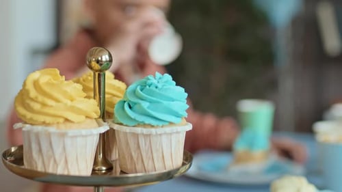 Leckere Cupcakes mit Sahne-Topping auf dem Tisch auf der Kinderparty