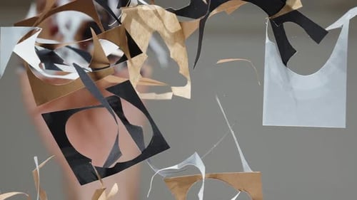 I clear away the cut colorful paper from the table. View from below through a glass table, in slow.