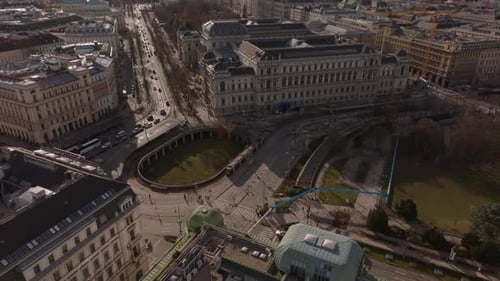 Aerial View of Traffic on Roads and Large Buildings in Historic City Center Tilt Up Reveal of