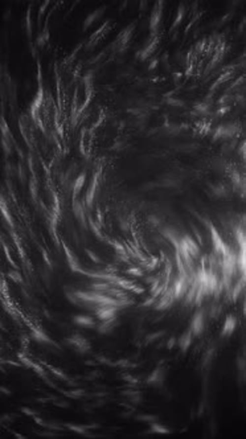 Swirling White Liquid on Dark Background
