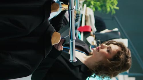 Vertical Video Smiling Retail Clerk Enjoys Working in a Fashion Boutique