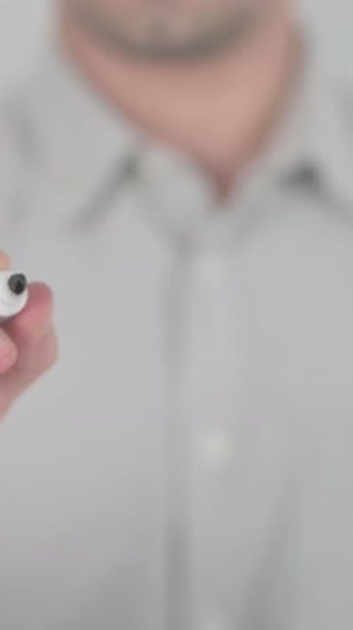 Man Writes Message on Transparent Surface with Marker