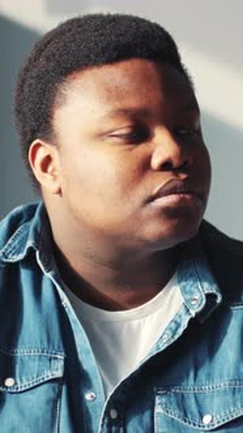 Portrait of Smiling Young Man in Denim Shirt