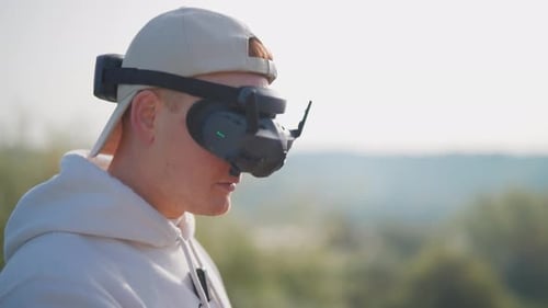 Rack focus transition to male wear fpv drone goggle headset, nature environment