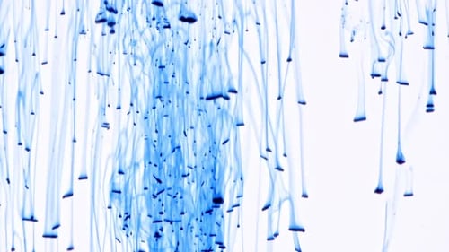 Abstract Blue Ink Dropping on White Background