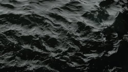 Dark Rippling Water Surface Seamless Loop Background