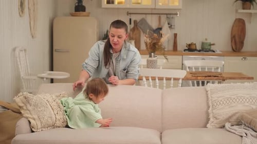Mother and Toddler Play on Couch at Home