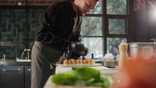 Chef Prepares Sushi Rolls with Sauce in Restaurant