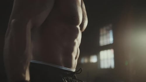 Man doing dumbbell curls in gym