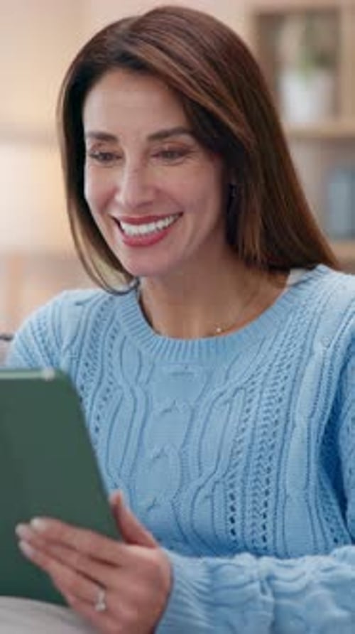 Smiling Woman Using Tablet at Home Indoors