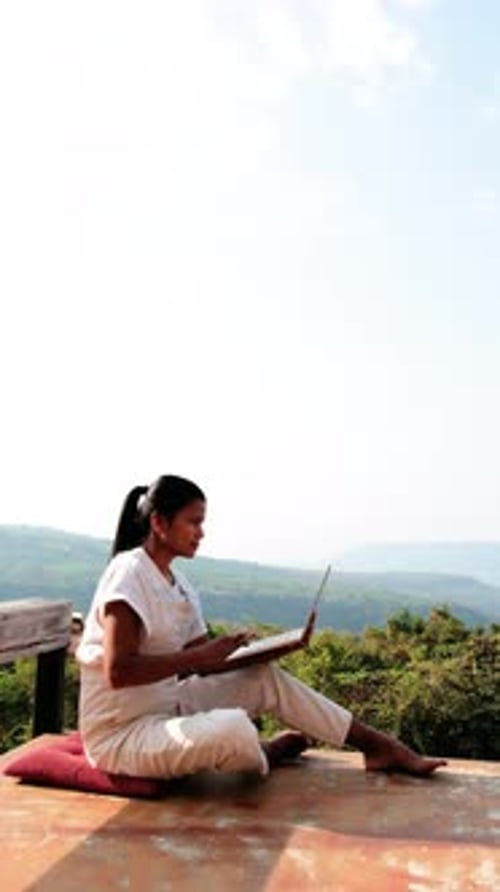 Woman Works on Laptop with Mountain View