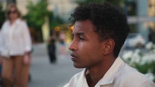 Young man observing city life