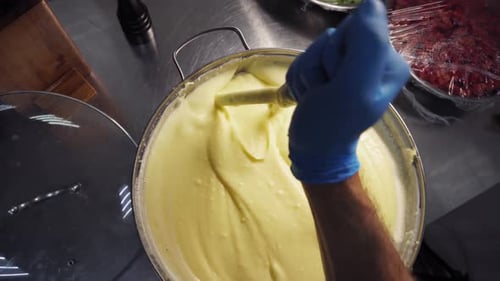 Chef Stirs Mashed Potatoes in Kitchen Overhead Shot