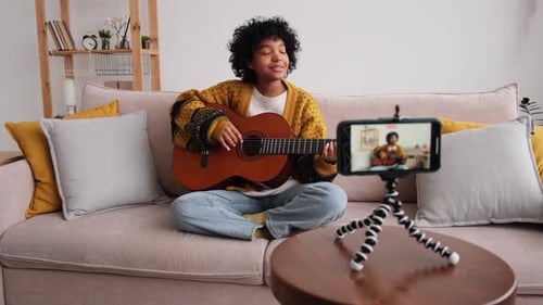 Young Adult Plays Guitar for Social Media