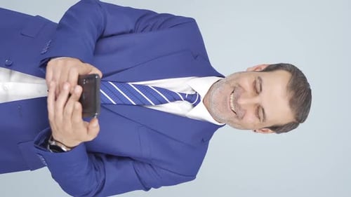 Adult Man Using Smartphone in Business Attire