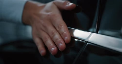 Close up young businessman checking anonymous just repaired in car auto body shop. Slow motion sho