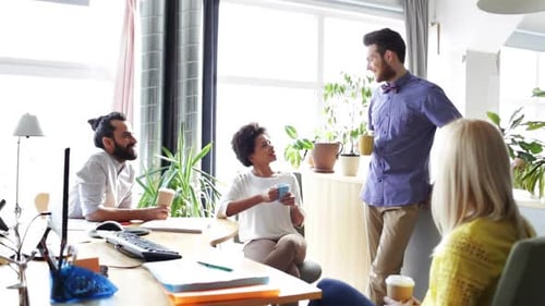 Business team talking casually in bright office