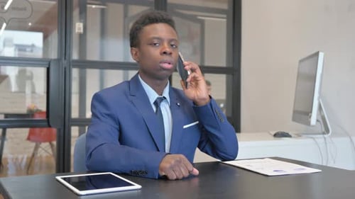 Young Adult Talking on Smartphone in Office Setting