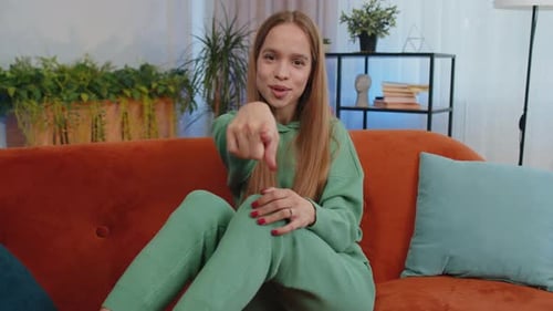 Young Smiling Girl Pointing to Camera Choosing Lucky Winner Indicating Inviting Approve at Home