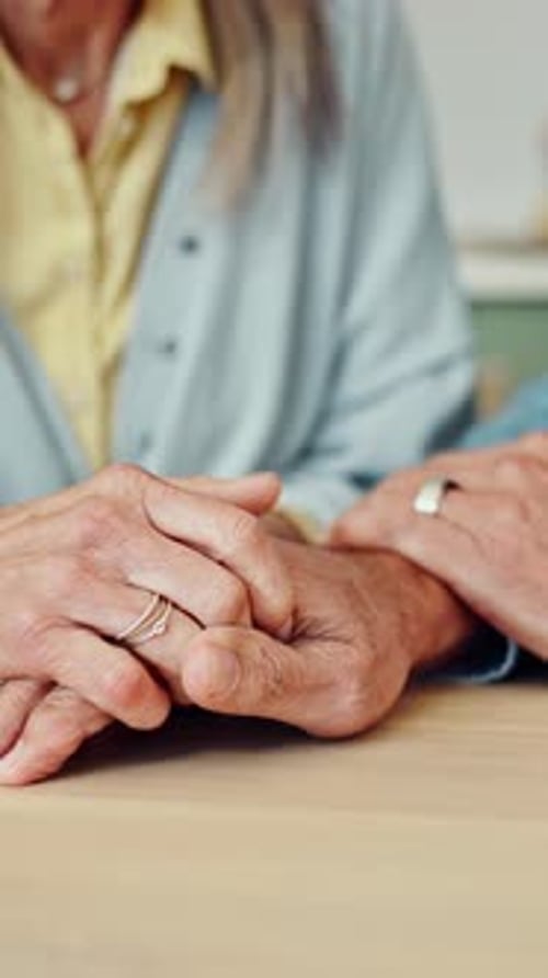 Holding hands, love and senior couple in home for care, empathy and trust for commitment