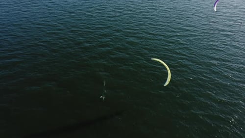 Kite Surfer Glides Across Dark Blue Ocean Water