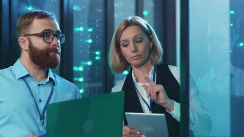 Man and Woman Working in Data Center