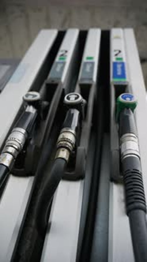 Hand Takes Gas Pump During Oil Crisis