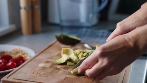 Avocado being cut on cutting board