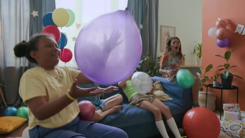 Children Play with Balloons at a Birthday Party