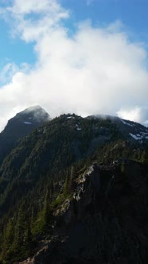 Mountain Peak Through The Clouds. British Columbia, Canada.