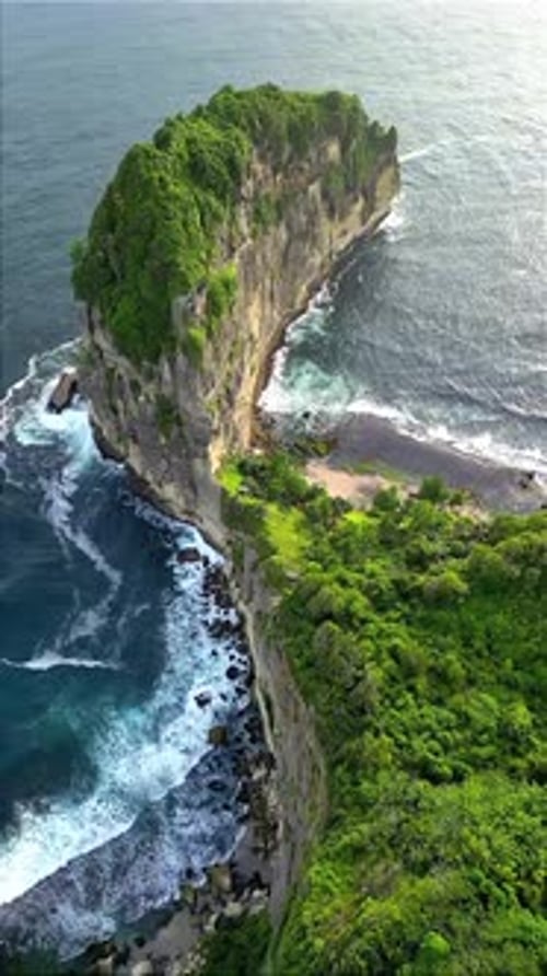 Drone Shot of Dramatic Green Cliffs and Ocean Waves